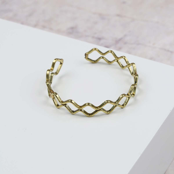 Enhance your wrist with this gorgeous slip on cuff bracelet, in an open style with a double row zigzag patterned finish.


