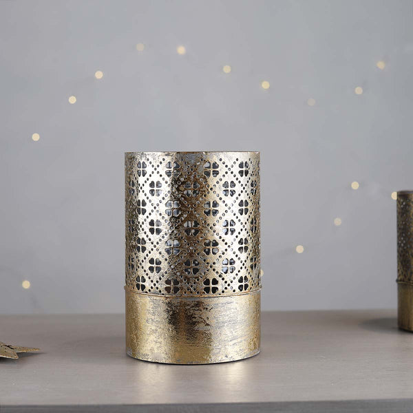 A stunning gold decorative candle holder with an inner glass, the light will dance through the cutout design.