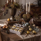 box of 9 small gold baubles