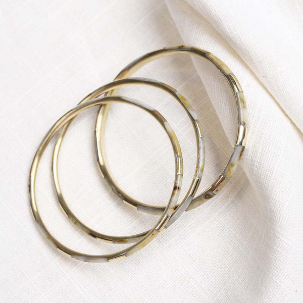 These 100% hand crafted bangles are made by artisans in India. They look great singularly or worn together, mix and match different styles and colours to make a statement.