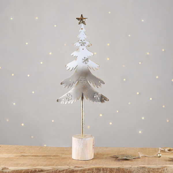 A festive grey and gold tree with gold  snowflakes and a star to top. Group a few trees together to make a great display.