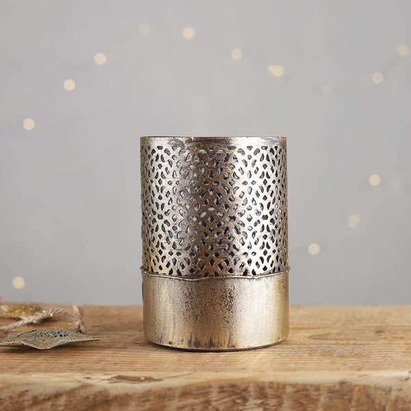 A stunning gold decorative candle holder with an inner glass, the light will dance through the cutout design.