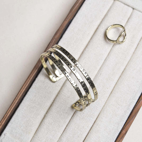 Define your wrist with this gorgeous slip on bangle, in an open style with a triple row patterned finish.