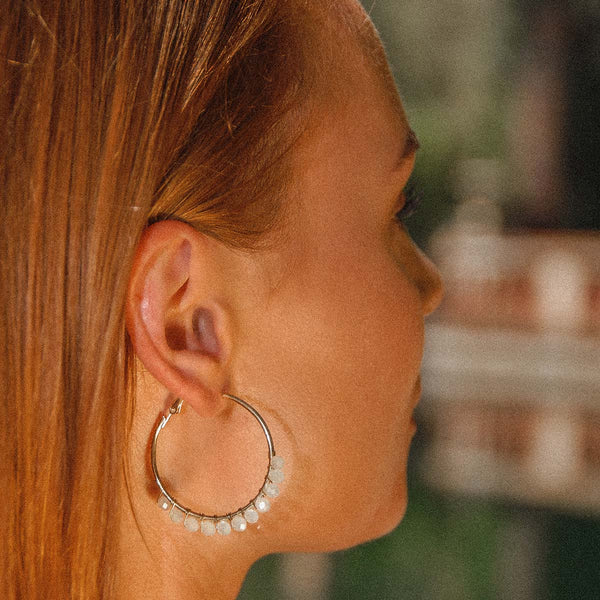 Make a statement with our gold and white crystal effect hoop earrings.
