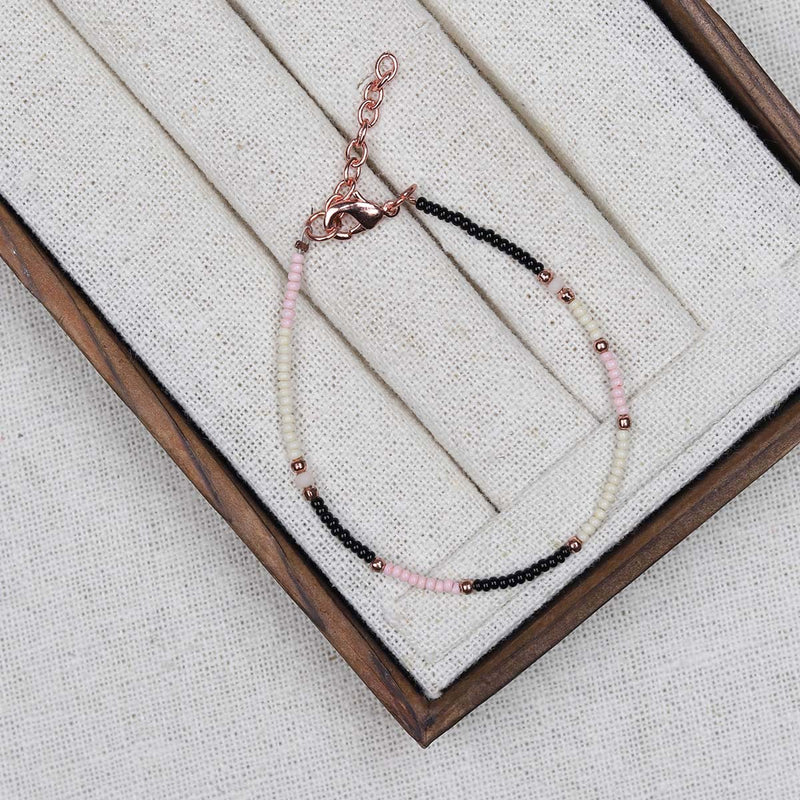 A beautiful summery bracelet in baby pink,black,cream and rose gold tiny beads, lovely on its own or group some together for a fun look.